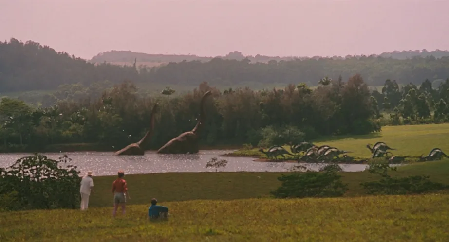 Grant, Sattler, and Malcolm looking out over a lake full of dinosaurs in Jurassic Park